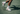 Tennis player's feet in white shoes and socks on a tennis court